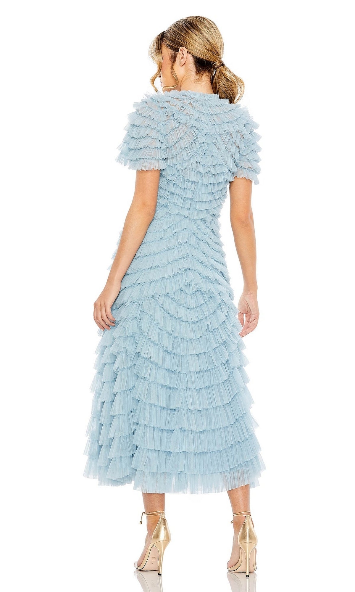 A woman faces away in the Midi Wedding Guest Dress 8055 by Mac Duggal—a pastel-tiered, short-sleeve ruffle midi dress paired with metallic platform heels, perfect for a stylish wedding guest look.
